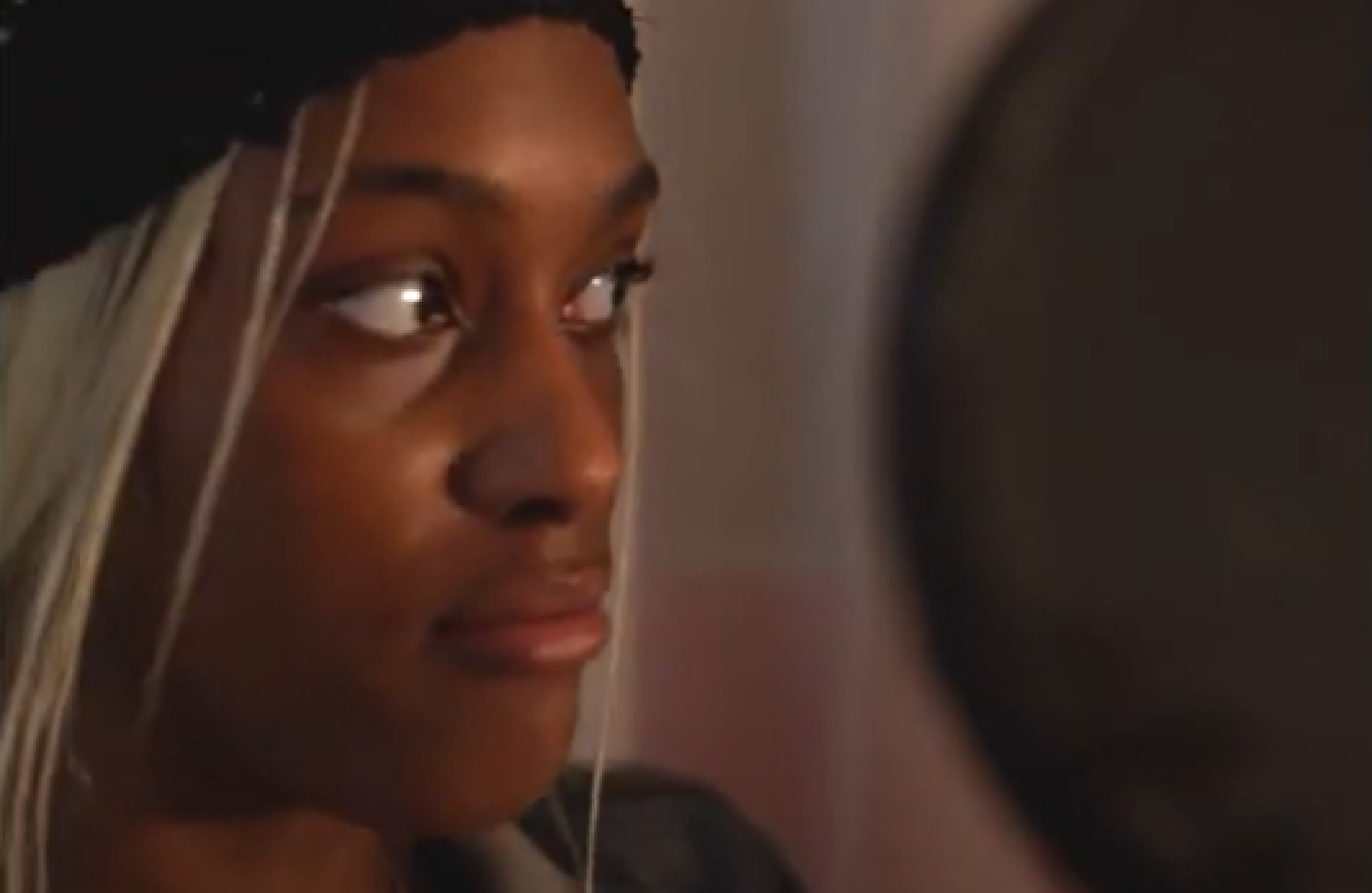 Keela speaks into a microphone and shares her experience in the juvenile justice system in Wisconsin.