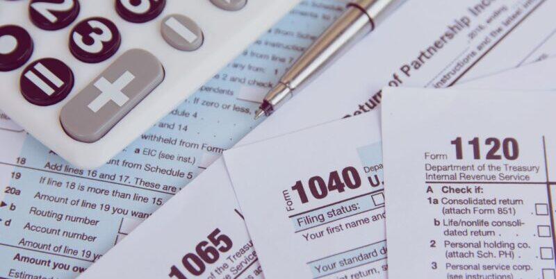 PXL_20240504_165906947 Image of calculator and paper tax forms.
