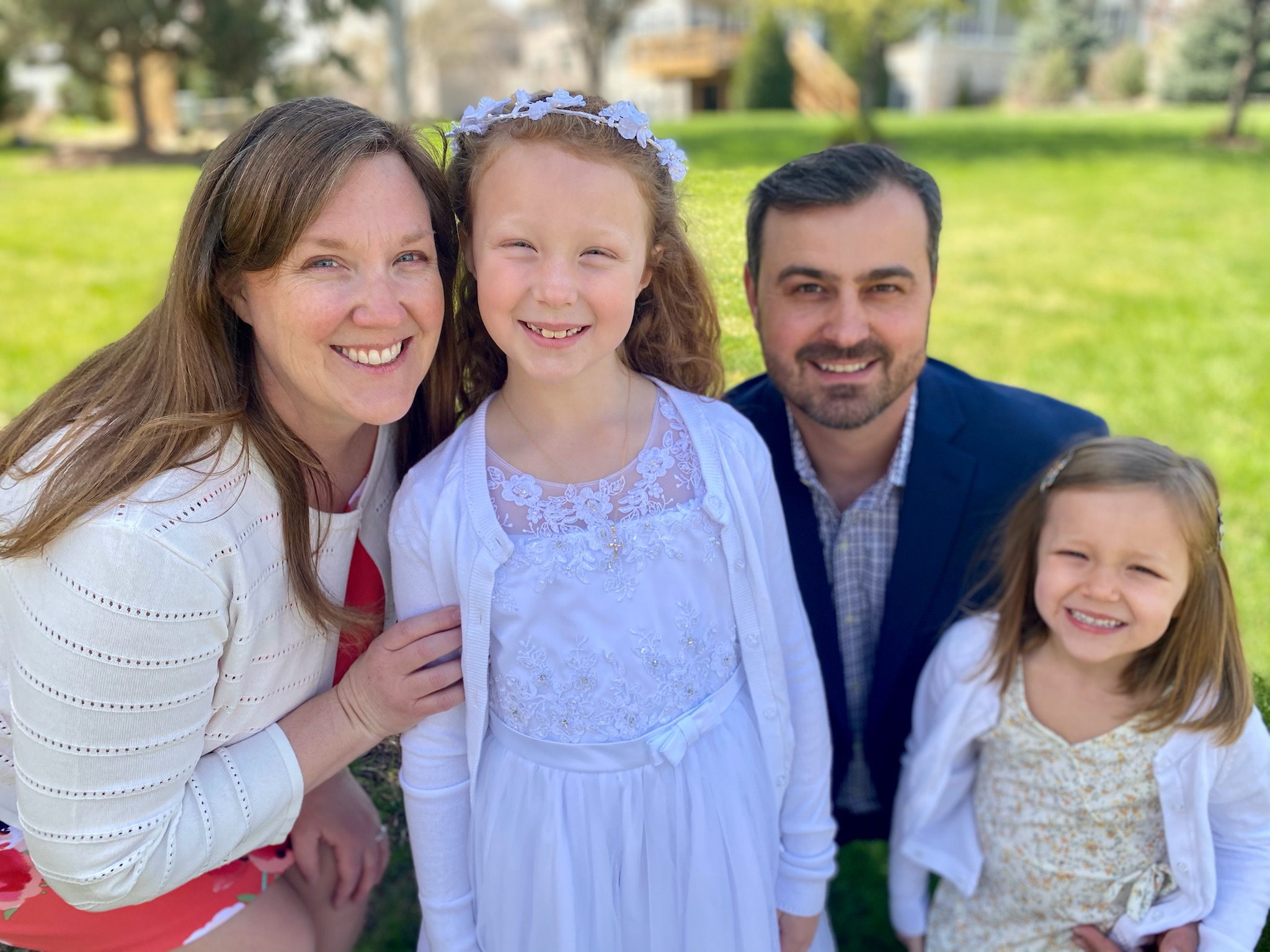 A family photo of Elizabeth Tomev with her husband and two daughters.