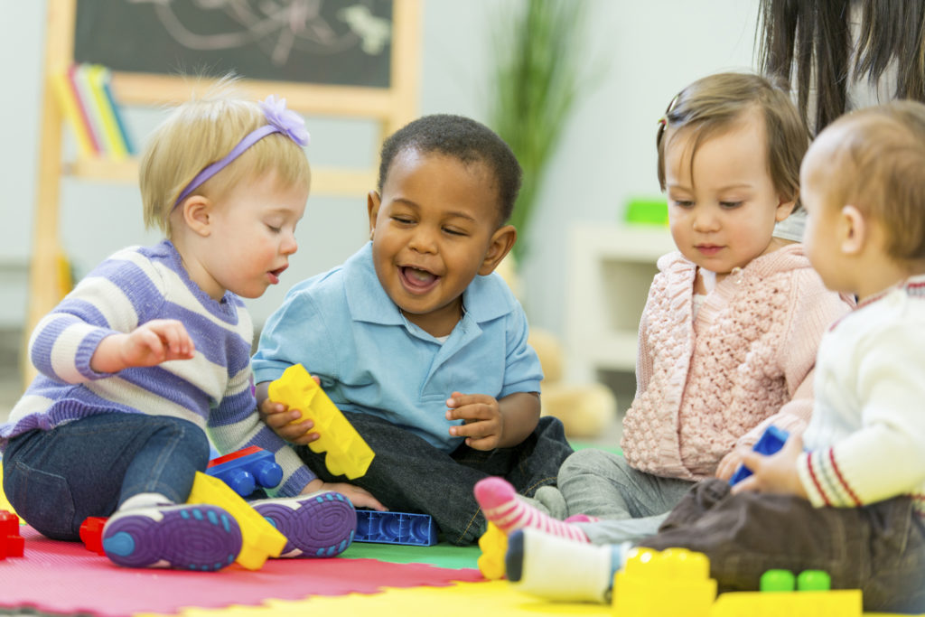 Group of babies playing together.